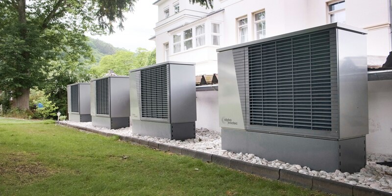 Exterior heating and cooling units beside a building