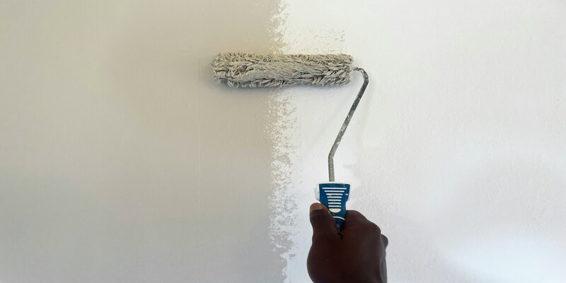 Fresh paint being rolled onto an interior wall