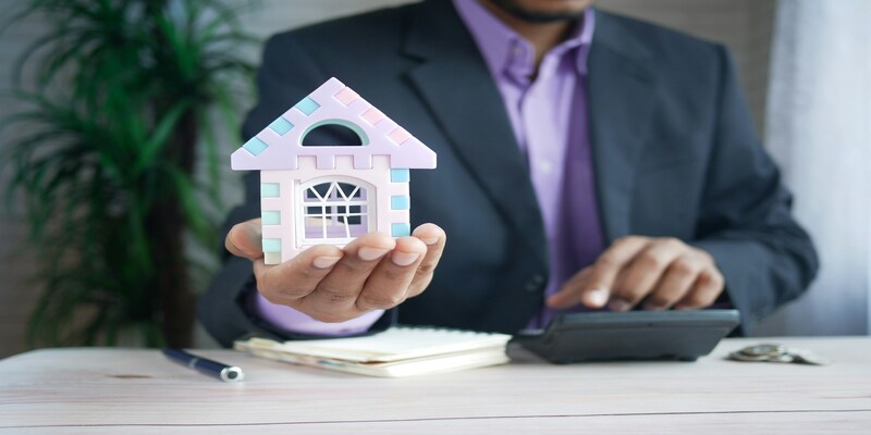 Property professional holding a model home